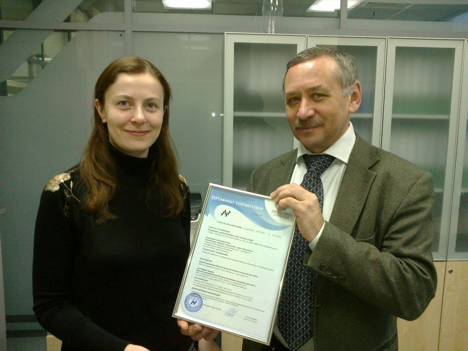 Yuri Toropov, CEO of Nanocertifica, awards Certificate of conformity for SPM FemtoScan to Olga Sinitsyna, responsible for the certification scientific researcher of Advanced Technologies Center